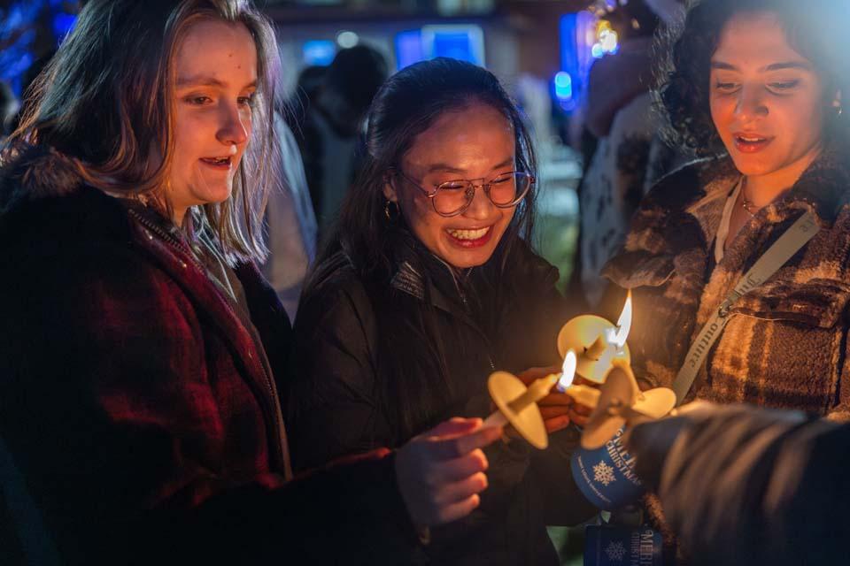 Attendees light candles during Christmas on the Quad on Dec. 6, 2025. Photo by Sarah Conroy.