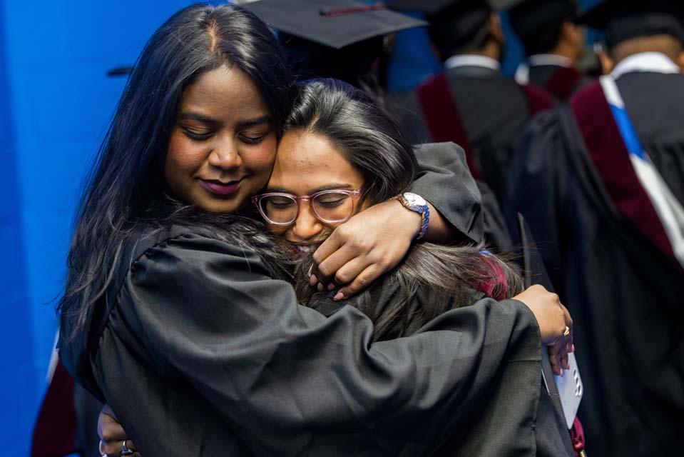 Graduates embrace before Midyear Commencement on Saturday 13, 2025. Photo by Sarah Conroy.
