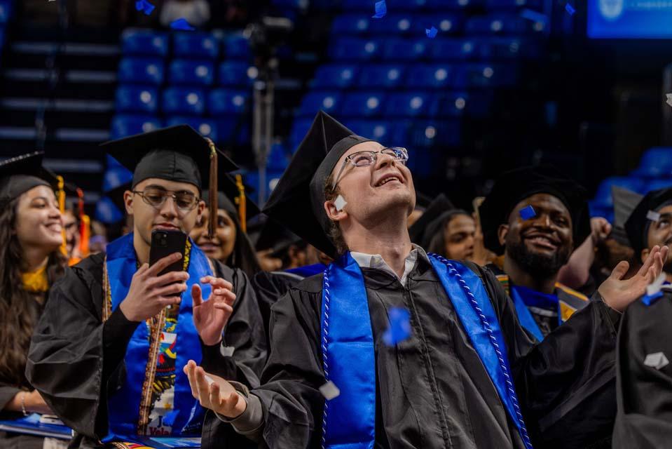 Graduates watch as confetti falls during Midyear Commencement on Saturday, Dec. 13, 2025. Photo by Sarah Conroy.