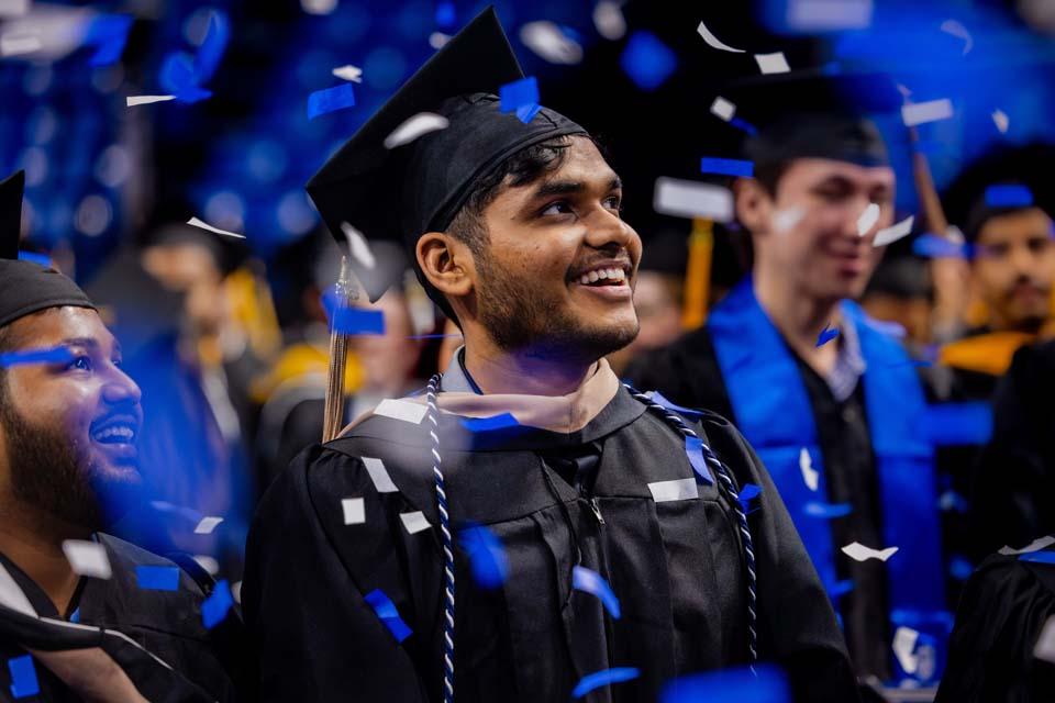 Graduates watch as confetti falls during Midyear Commencement on Saturday, Dec. 13, 2025. Photo by Sarah Conroy.