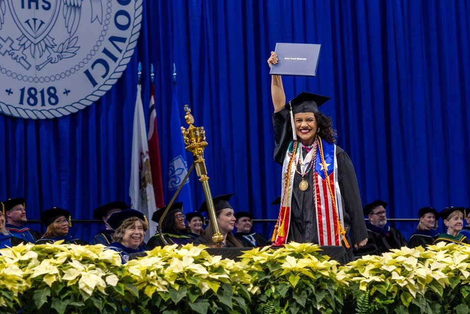 A graduate celebrates after receiving her diploma during Midyear Commencement on Dec. 13, 2025. Photo by Sarah Conroy.