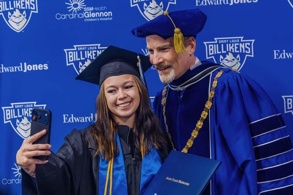 A graduate takes a selfie with President Edward Feser, Ph.D., after Midyear Commencement on Saturday, Dec. 13, 2025. Photo by Sarah Conroy.