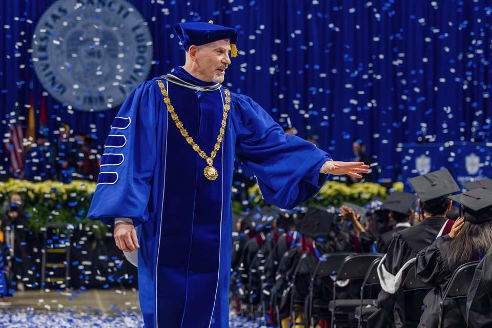 President Edward Feser, Ph.D., waves to the graduates after Midyear Commencement on Dec. 13, 2025. Photo by Sarah Conroy.