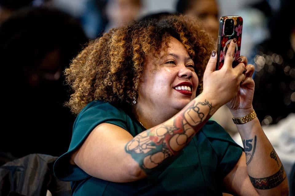 An attendee records gospel singer Vanessa Bell Armstrong during the 2026 Martin Luther King Jr. Memorial Tribute on Jan. 22, 2026. Photo by Sarah Conroy.