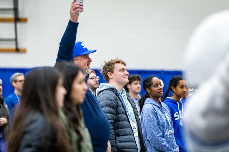 Admitted students and their families divide into two groups as they learn SLU cheers.
