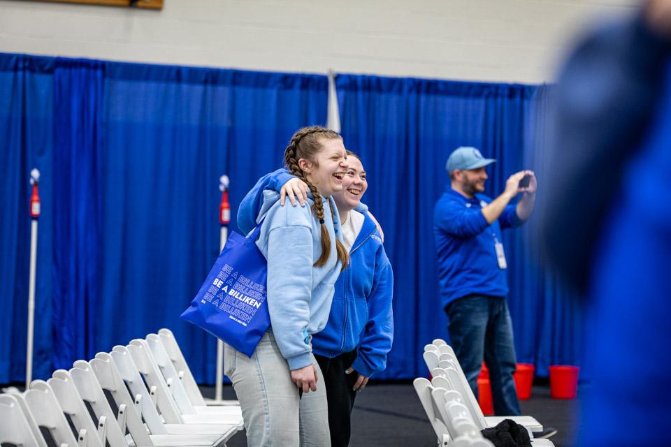 Admitted students hug and wave as they learn SLU's game-day cheers.