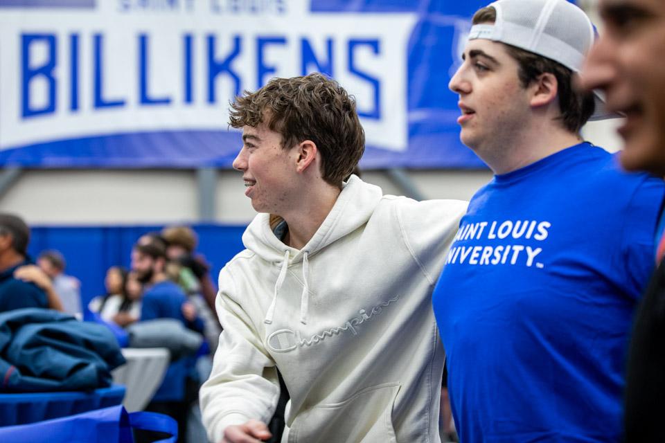 Admitted students sway back and forth as they learn SLU cheers.