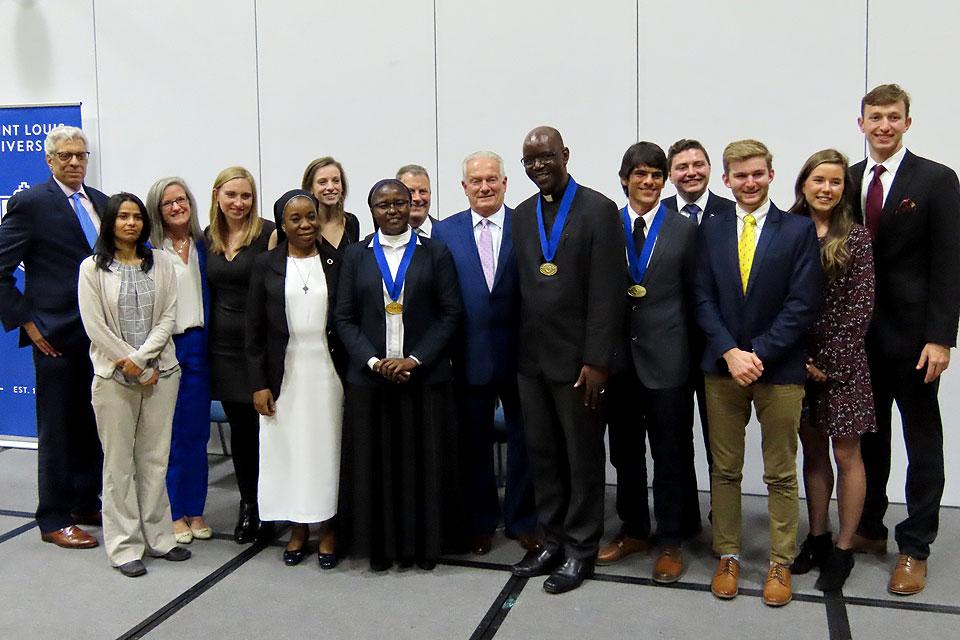 The 2019 Opus Prize finalists, along with SLU President Fred P. Pestello, Ph.D. and the SLU student, faculty and staff ambassadors. Photo by Amelia Flood. 