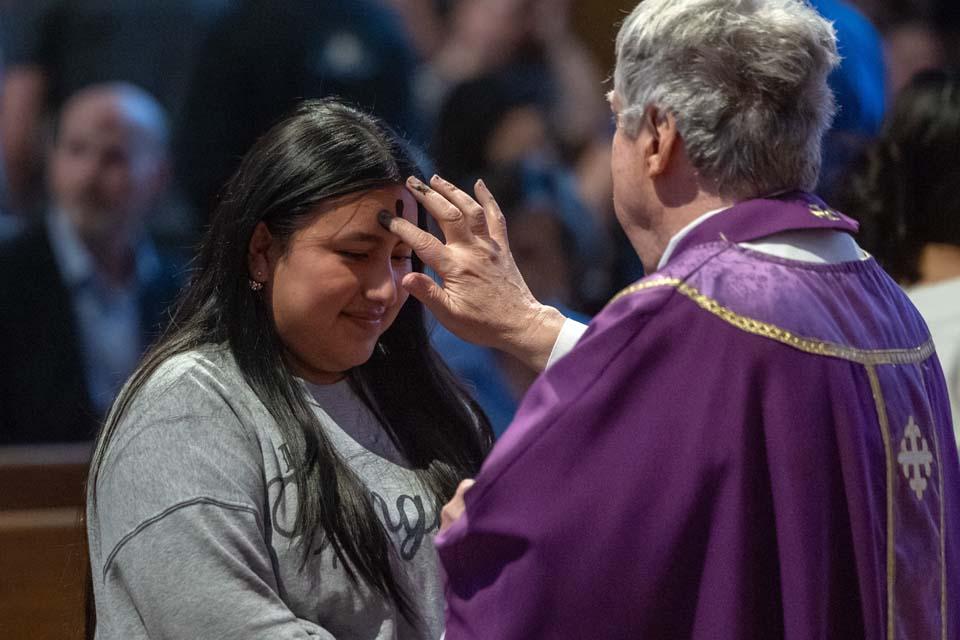 A member of the SLU community receives ashes during Ash Wednesday Mass on Feb. 18, 2026. Photo by Sarah Conroy.