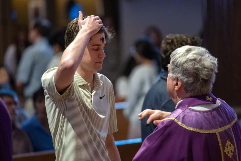 A member of the SLU community receives ashes during Ash Wednesday Mass on Feb. 18, 2026. Photo by Sarah Conroy.