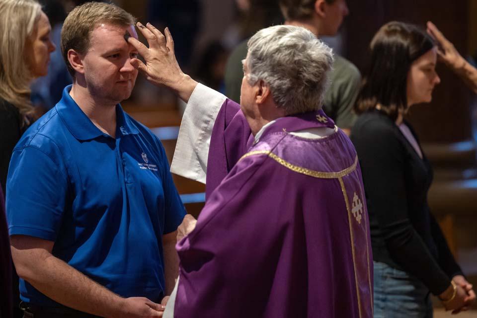 A member of the SLU community receives ashes during Ash Wednesday Mass on Feb. 18, 2026. Photo by Sarah Conroy.