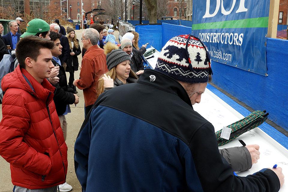 Students, faculty and staff braved a brisk day to celebrate the topping-out and to sign the beam marking a key construction milestone. Photo by Amelia Flood
