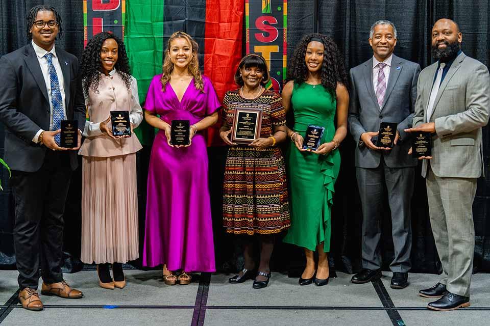a group of people pose with awards