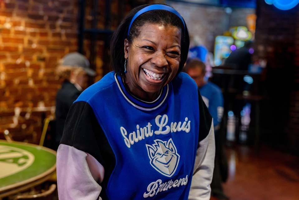 Billikens fan Audra Smith, Ph.D., reacts to the team’s 88-81 victory over George Washington University in the A-10 quarterfinals during a watch party at Humphrey’s Restaurant and Tavern on March 13, 2026. Photo by Sarah Conroy.