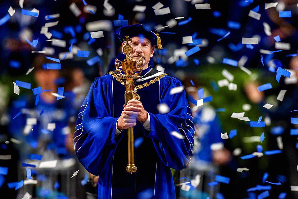SLU President Dr. Edward Feser holds the University mace during his inauguration in November 2025.