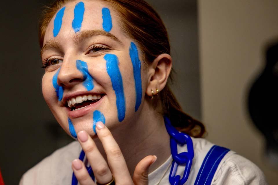 Students paint their faces before the first round game of the NCAA Tournament in Buffalo, NY on March 19, 2026. Photo by Sarah Conroy. 