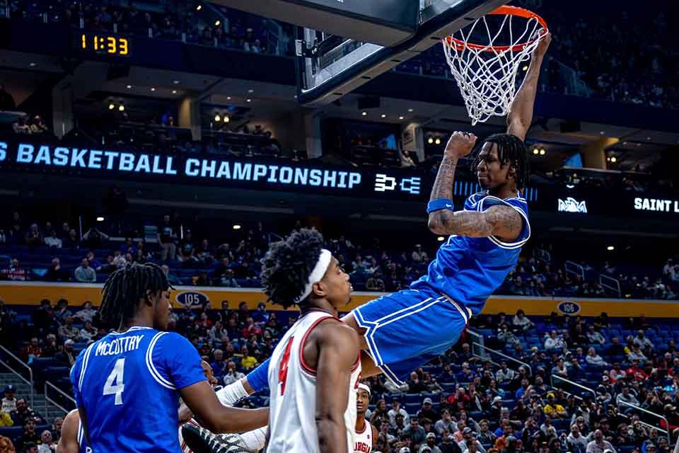 Quinton Jones hangs from the rim during Round 1 of the NCAA Tournament against the University of Georgia at the Keybank Center in Buffalo, NY on March 19, 2026. Photo by Sarah Conroy. 