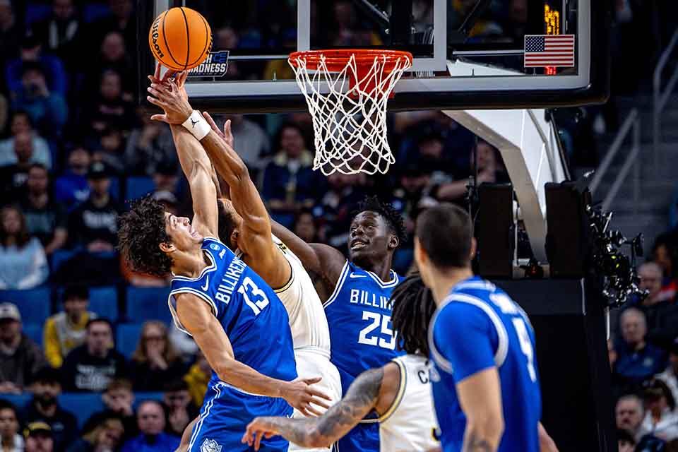 Dion Brown and Paul Otieno fight for a rebound during the Second Round of the NCAA Tournament against the University of Michigan in Buffalo, NY on March 21, 2026. Photo by Sarah Conroy. 