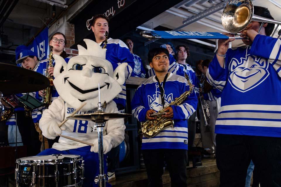 The Billiken joins the pep band on drums during a pep rally at The Draft Room in Buffalo, NY on March 18, 2026. Photo by Sarah Conroy. 