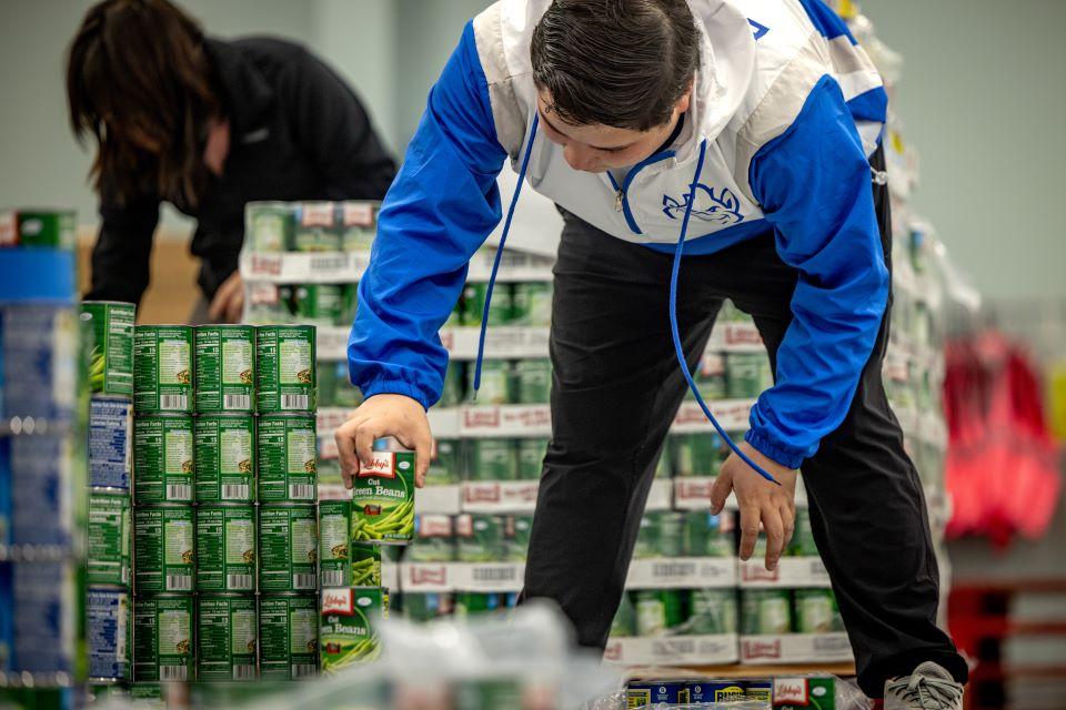 Members of SLU's American Society of Civil Engineers (ASCE) participate in a practice build for Operation Food Search's CANstruction. Photo by Sarah Conroy. 