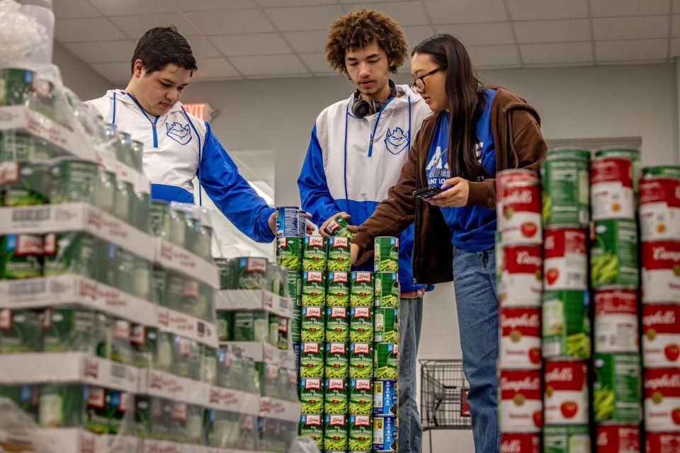 Members of SLU's American Society of Civil Engineers (ASCE) participate in a practice build for Operation Food Search's CANstruction. Photo by Sarah Conroy. 
