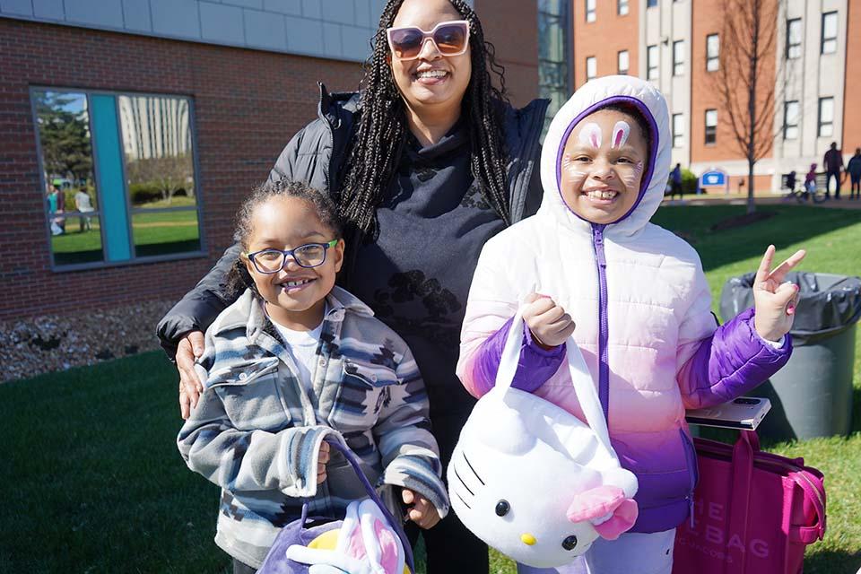 A family poses for a photo to show off their new face paint at the Easter Egg Hunt on March 28, 2026. Photo by Megan Favignano-Mansouri.