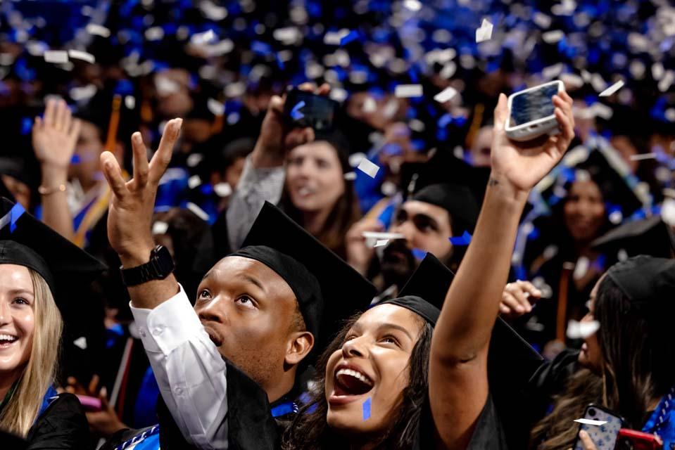 SLU graduates celebrate as confetti falls. Photo by Sarah Conroy.