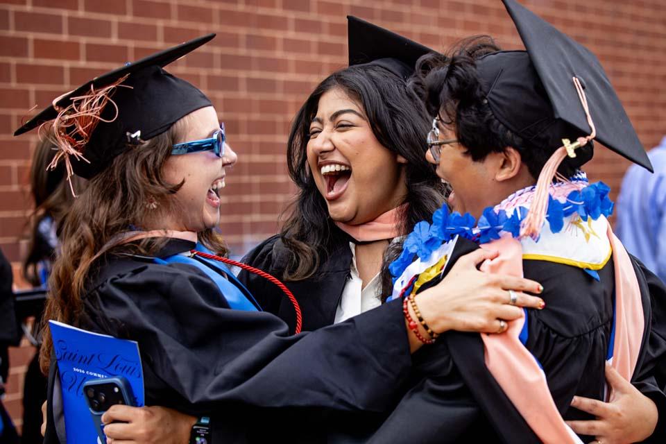 Graduates share a hug after commencement on Saturday, May 16, 2026. Photo by Sarah Conroy.