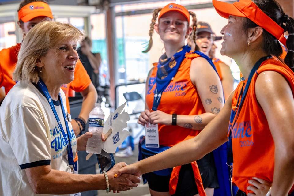 Kathy Johnson, Ph.D., executive vice president and provost greets members of Oriflamme on Friday, Aug. 14, 2026. Photo by Sarah Conroy.