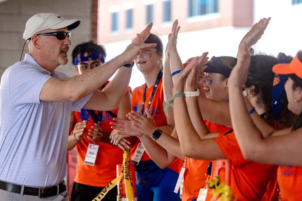 SLU President Ed Feser, Ph.D., high-fives Oriflamme members during the Aug. 14, 2026, move-in Photo by Sarah Conroy.