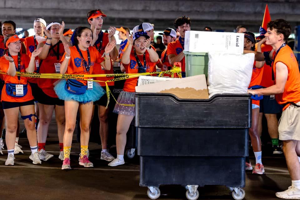 Members of Oriflamme cheer as new students are moved into residence halls on Friday, Aug. 14, 2026. Photo by Sarah Conroy.