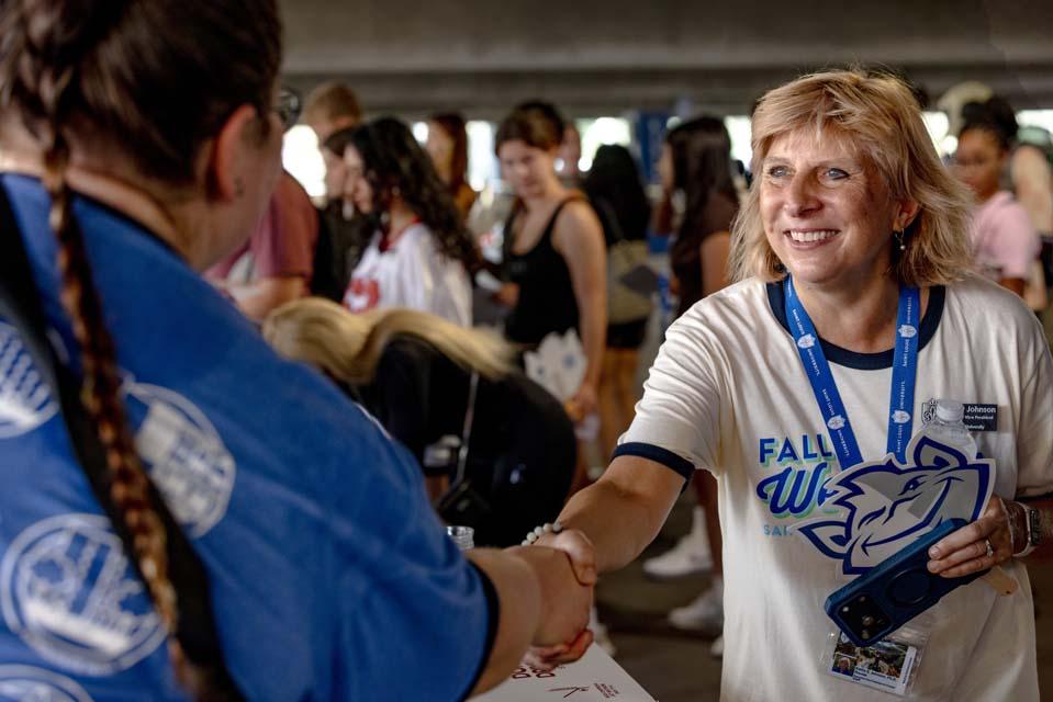 Kathy Johnson, Ph.D., executive vice president and provost greets members of Oriflamme on Friday, Aug. 14, 2026. Photo by Sarah Conroy.