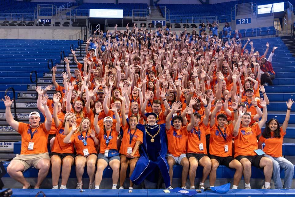 SLU President Edward Feser, Ph.D., poses with Oriflamme and members of Housing and Residential Life during convocation on Aug. 18, 2026.