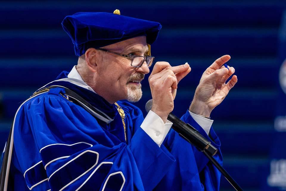 President Edward Feser, Ph.D., shows off the tiny Billikens during convocation on August 18, 2026. Photo by Sarah Conroy.