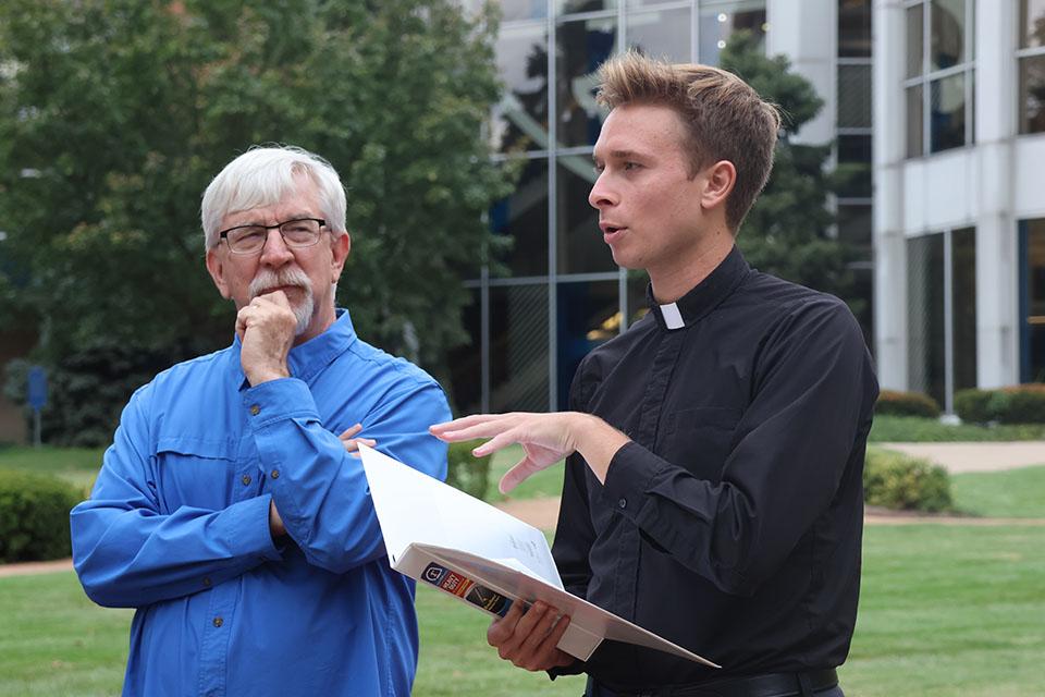 Gregory Beabout, Ph.D., professor of philosophy and the organizer of the Camino, listens to the opening reflection from Jesuit scholastic Francois Venne. Photo by Maggie Rotermund.