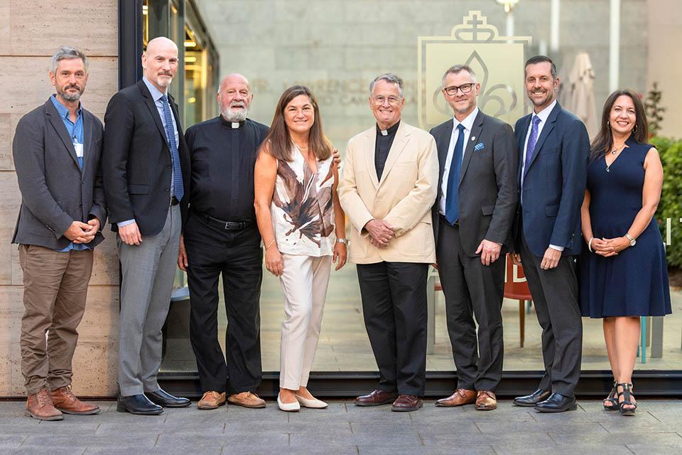 From left, Timothy Ryan Day, Ph.D.; President Edward Feser, Ph.D.; President Emeritus Lawrence Biondi, S.J.; Viki Villarreal, Frank Reale, S.J.; William Johnson, J.D.; Eric Engler, Chairman of the Board of Trustees; and Laurie Mazzuca, Ph.D., after the installation of Reale’s portrait at San Ignacio Hall in SLU-Madrid on Sept. 22, 2026. Photo by Sarah Conroy.