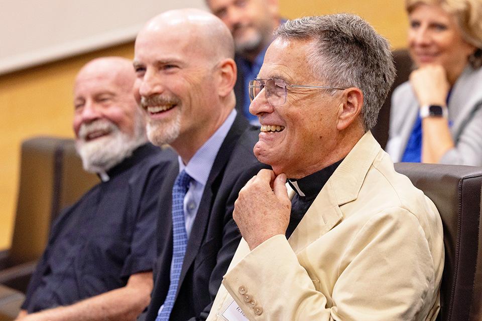 From left, President Emeritus Lawrence Biondi, S.J., President Edward Feser, Ph.D., and former SLU-Madrid Rector Frank Reale, S.J., share a lighthearted moment during the recognition ceremony honoring Fr. Reale at San Ignacio Hall on Sept. 22, 2026. Photo by Sarah Conroy.