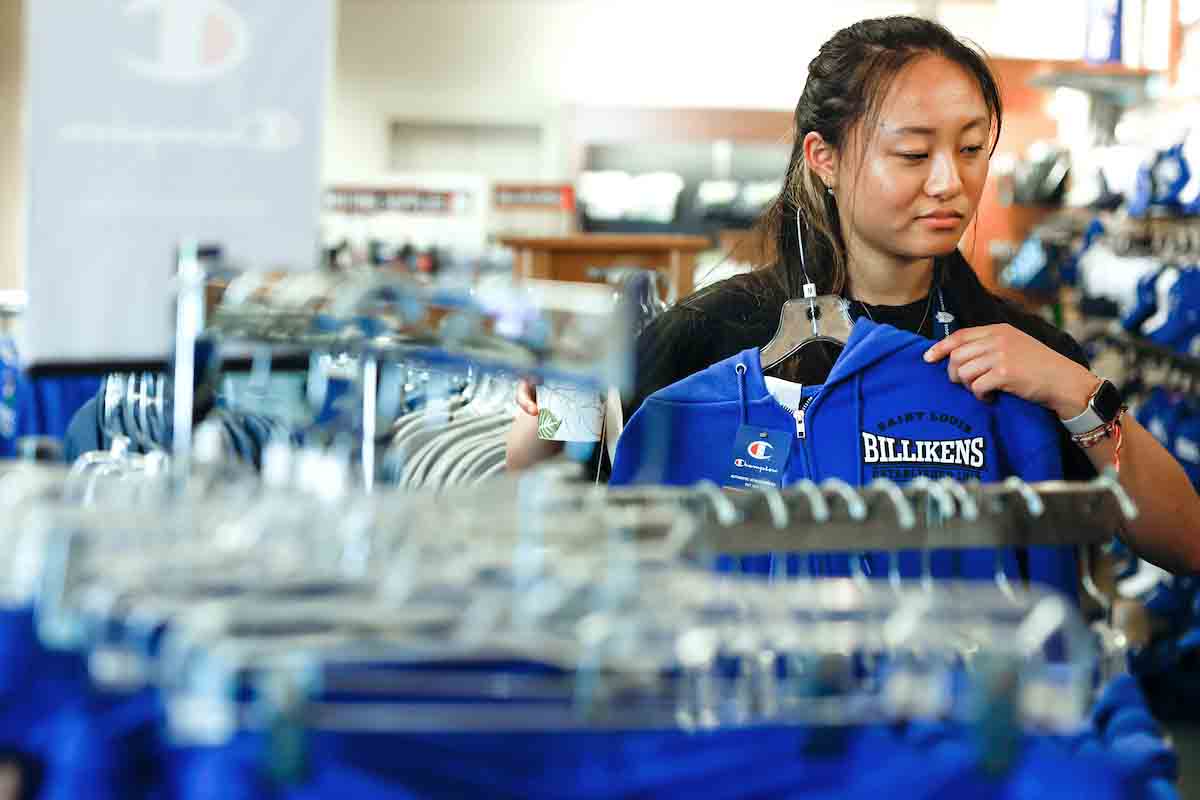 Female student wearing SLU Gear shopping at the bookstore