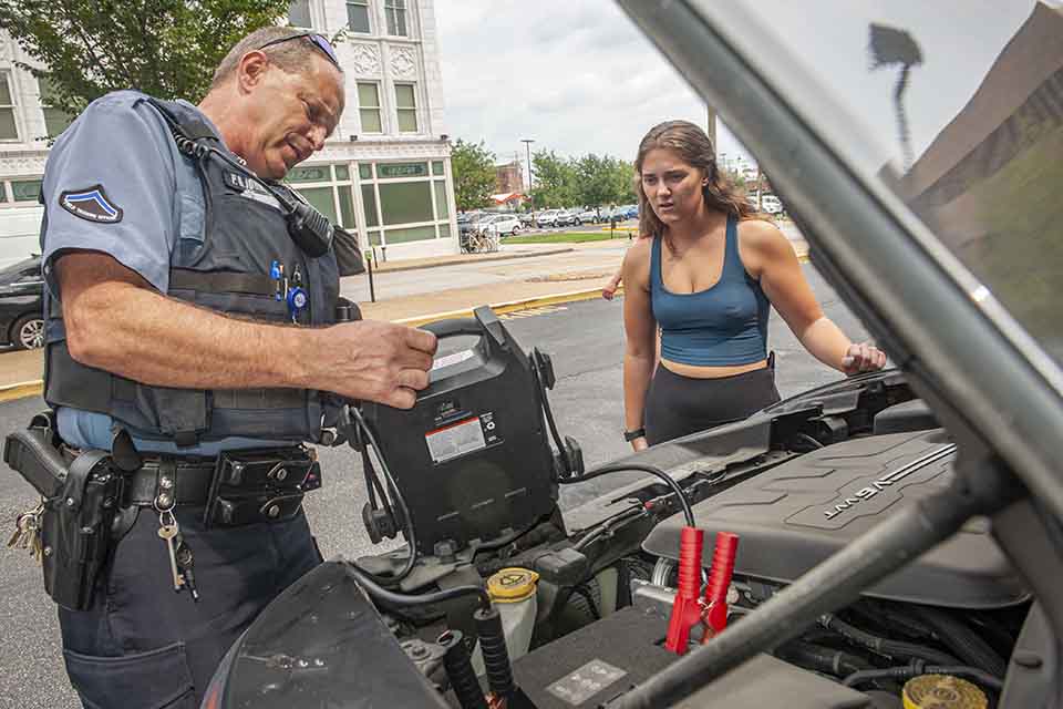 DPS officer helping a student with a jump start
