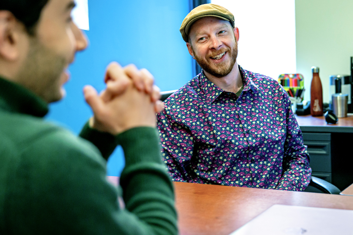 advisor and student sit at a table