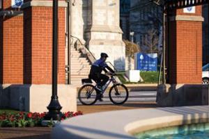 DPS officer on bike patrol near campus gates