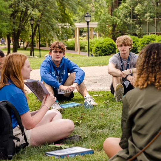 Students sitting with their SLU101 group leader