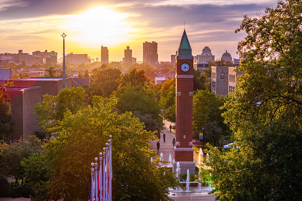 Clock tower on campus at sunset.