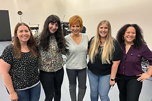 A group of four women, including Leah (Ducey) Dougherty, pose for a photo with Reba McEntire.