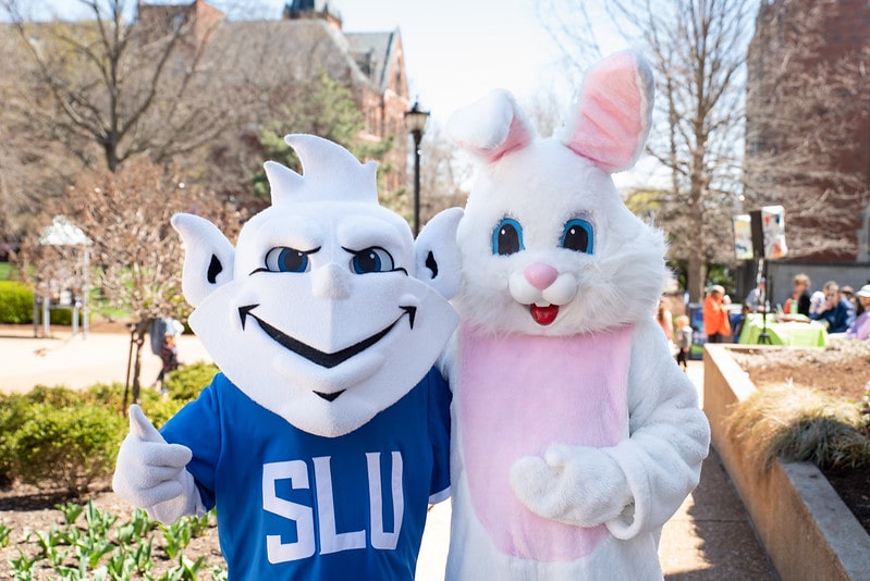 The SLU Billiken and the Easter bunny pose for a photo outside during the annual Easter Egg Hunt.