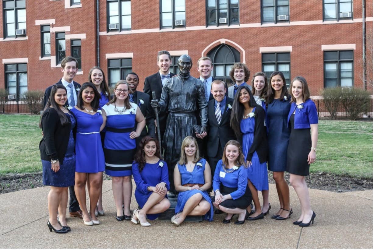 Spirit of the Billiken 2015 winners pose for a group photo outside with a statue of St. Thomas Aquinas