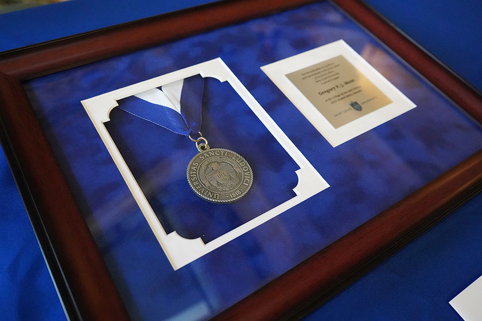 A medal inside a frame on a table.