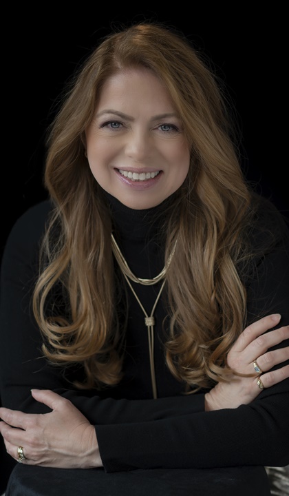 Headshot of Laurie Shortnick, wearing a black blouse and smiling.