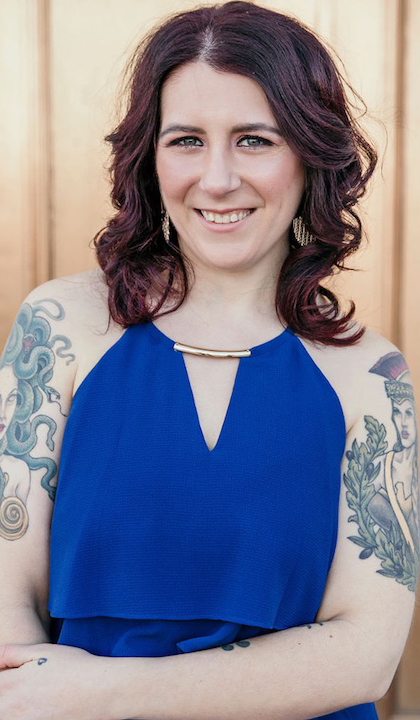 A portrait of Kelsey-Mesmer wearing a blue dress