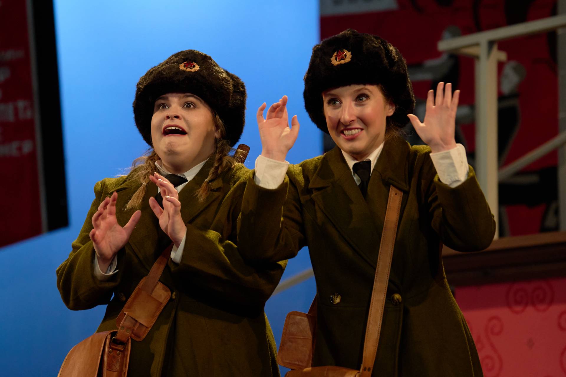 Two women in Russian uniforms look excited.